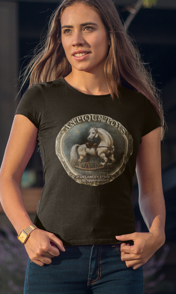 Woman wearing a fashionable tshirt featuring an ad of antique toys in a victorian style