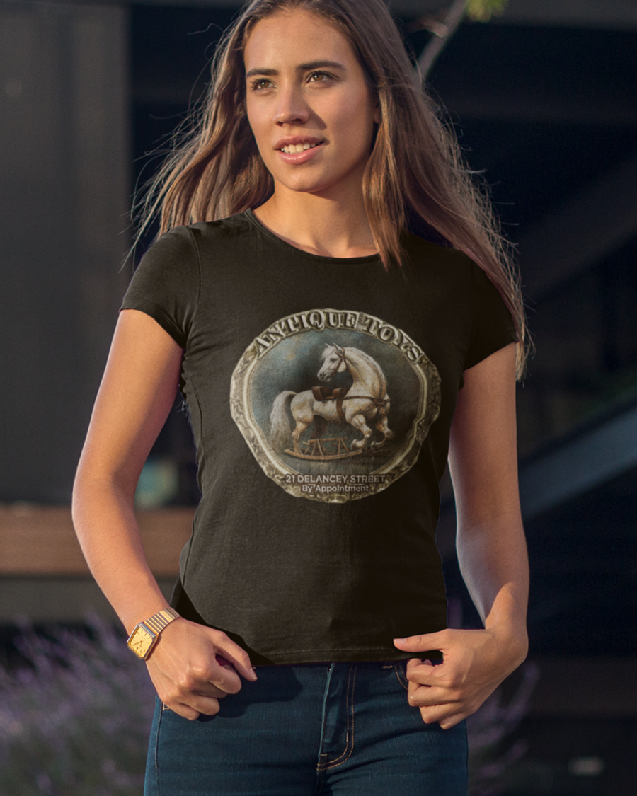 Woman wearing a fashionable tshirt featuring an ad of antique toys in a victorian style